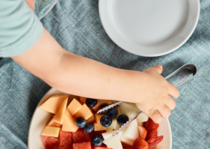 Child reaching for fruit
