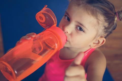 Young child drinking from a water bottle
