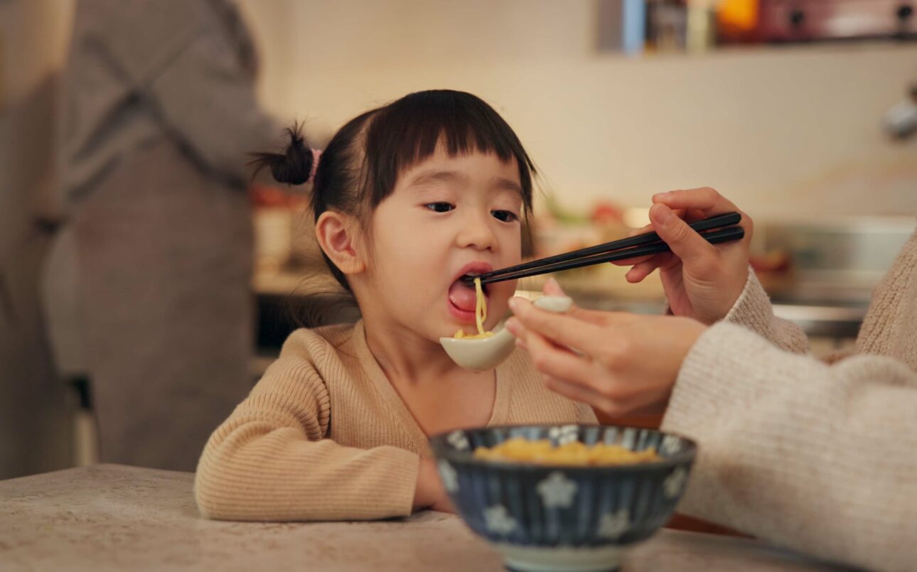 girl eating noodles