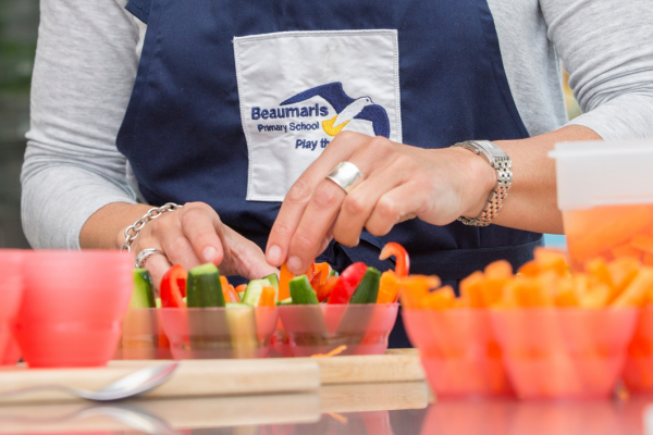 Hands sorting veggies in cups