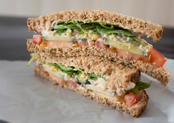 Sandwich with lettuce, tomato, corn and mayo
