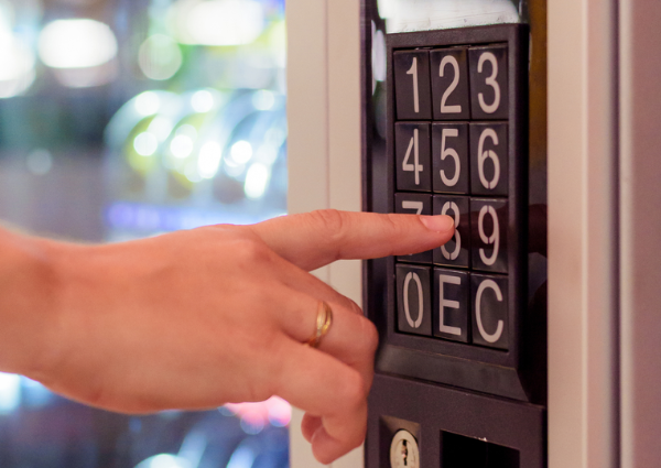 finger pressing key pad