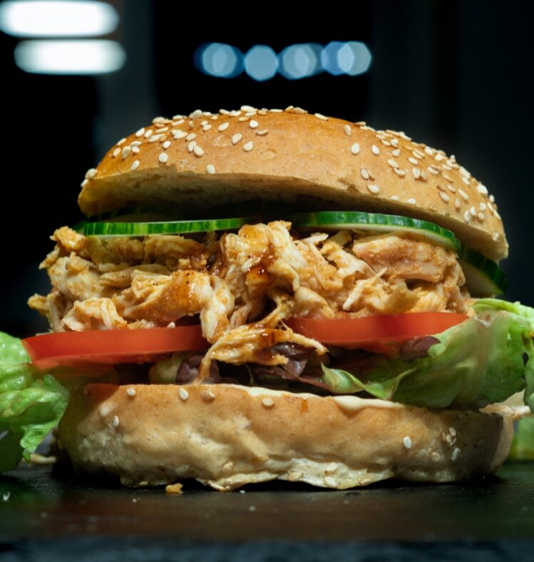 tandoori chicken burger on dark background