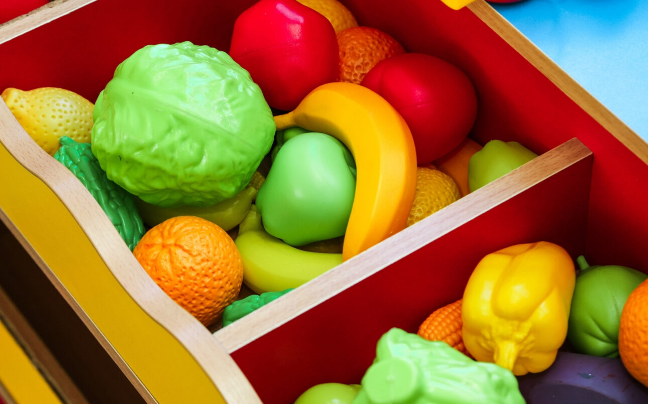 Mix of fruit and vegetable toys in a box