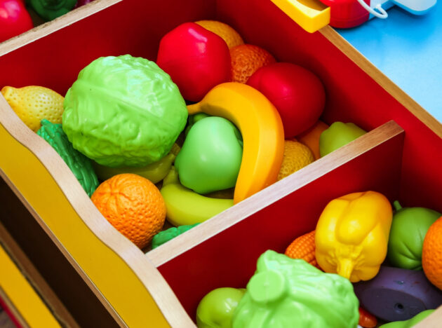 Mix of fruit and vegetable toys in a box