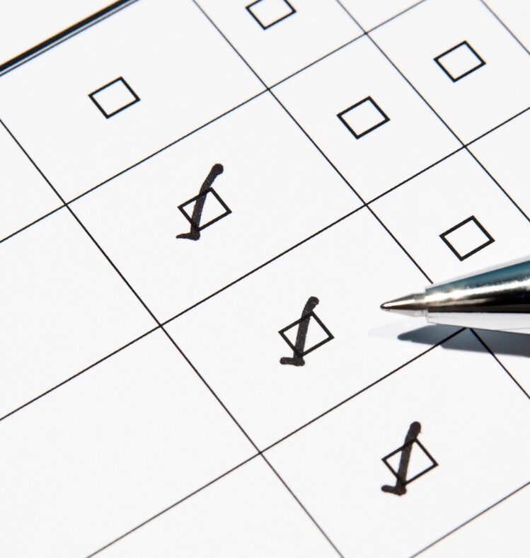 Pen ticking boxes on a checklist
