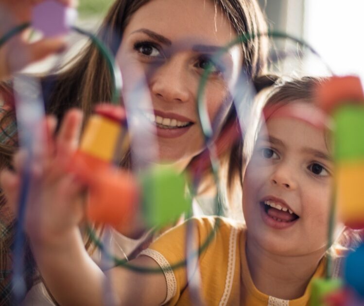 Child and parent playing with a toy