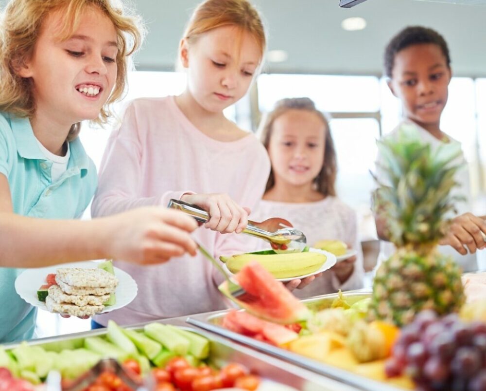 Children collecting meals from a healthy buffet