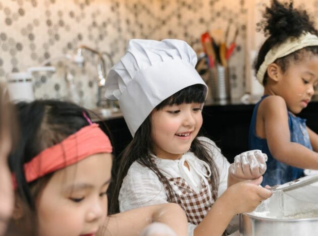 Children preparing food in a kitchen