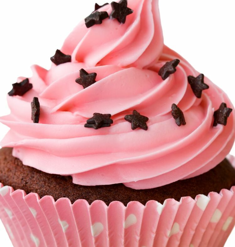 Cupcake with pink icing and chocolate star sprinkles