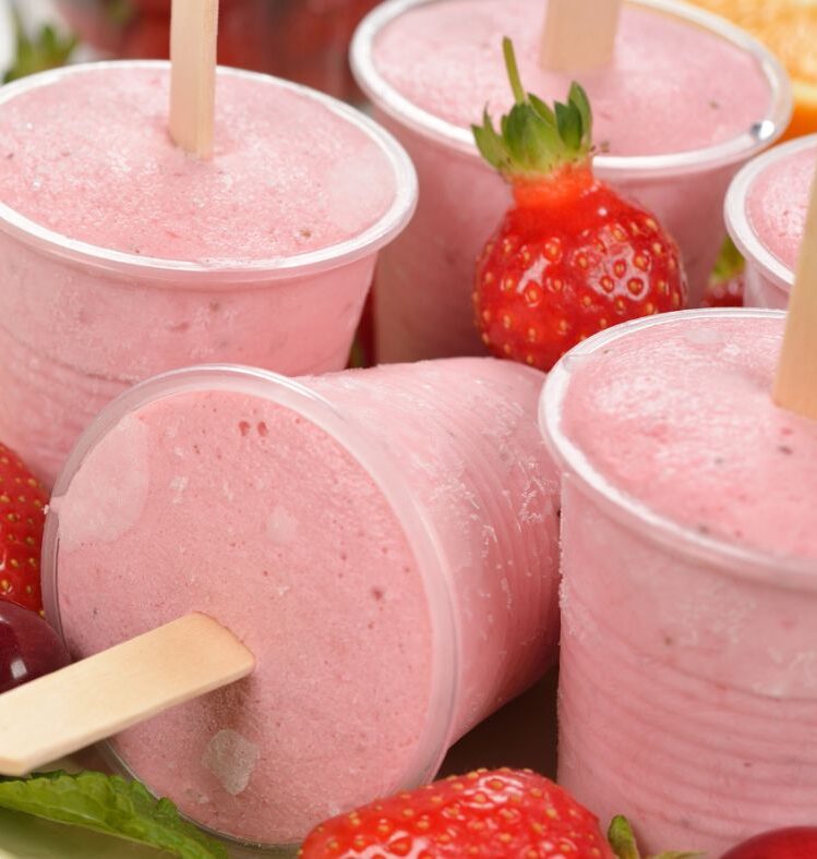 Pink fruit yoghurt popsicles in cups