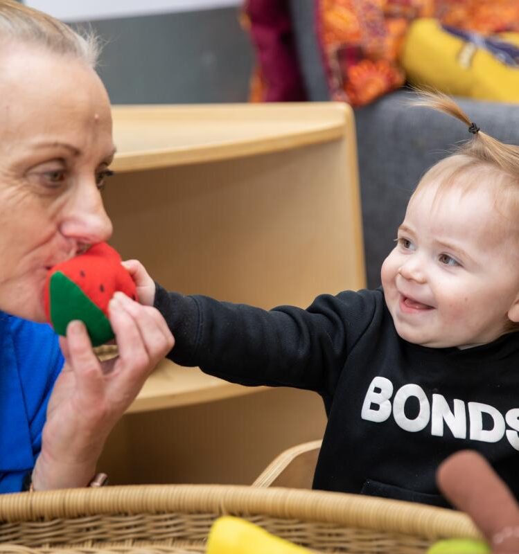Happy child with watermelon soft toy