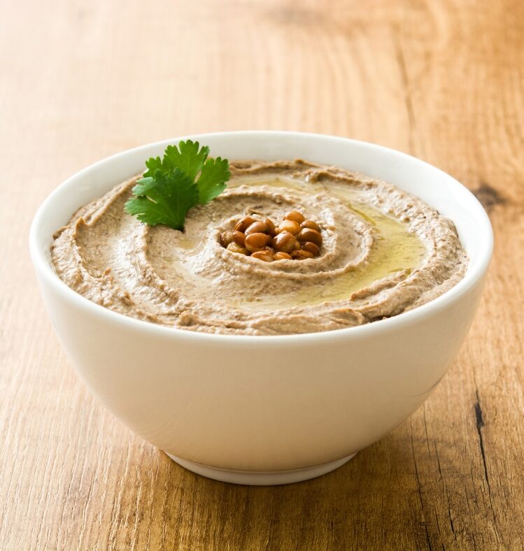 bowl of hummus with parsley garnish