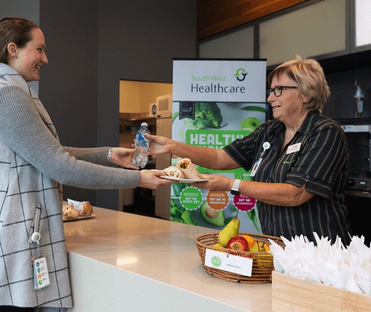 Staff member receiving food at a canteen