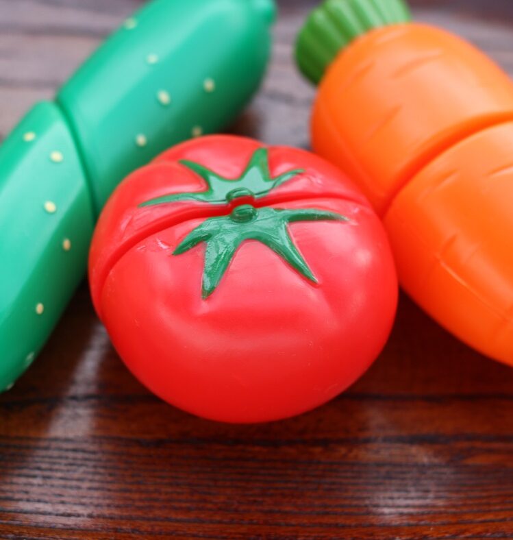 Plastic vegetable toys on table