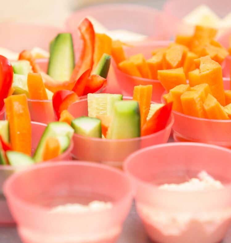 Cups of cut up vegetables with dip