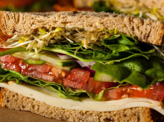 Salad and cheese sandwich cut in half