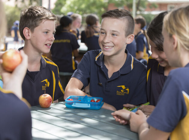 School children sitting outside at lunch