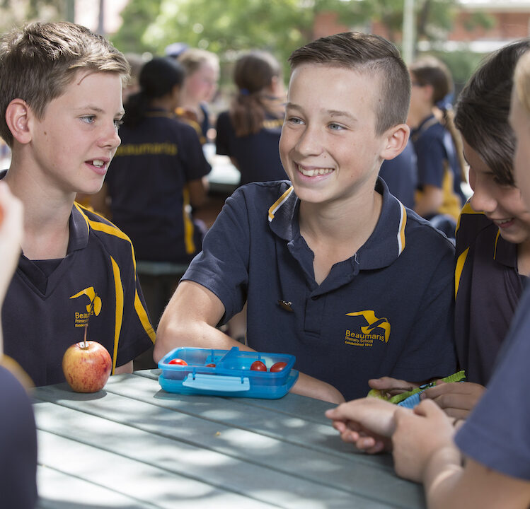 School children sitting outside at lunch