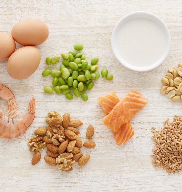 Seafood, nuts, eggs and milk in piles on a table top