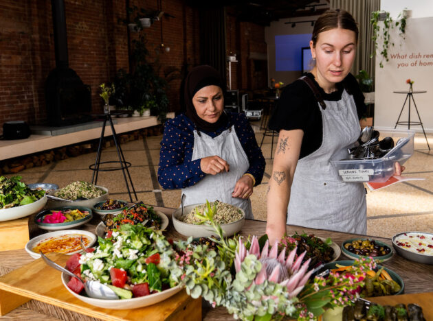Two staff members setting up food