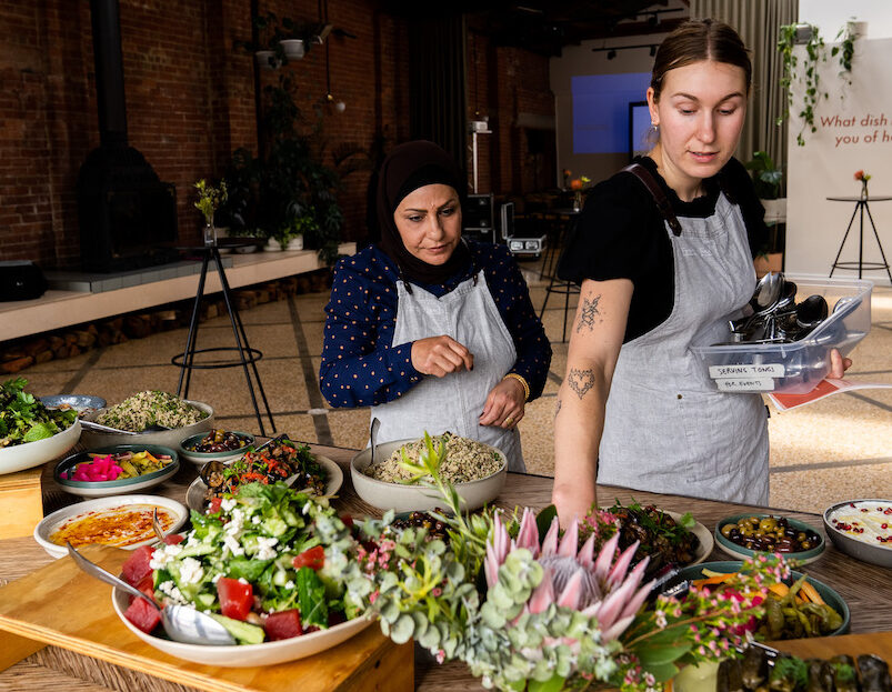 Two staff members setting up food