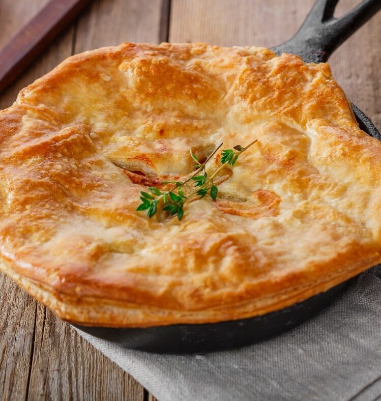 tandoori chicken pie with thyme leaves on top