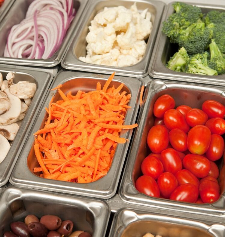 Numerous small metal tubs filled with different vegetables
