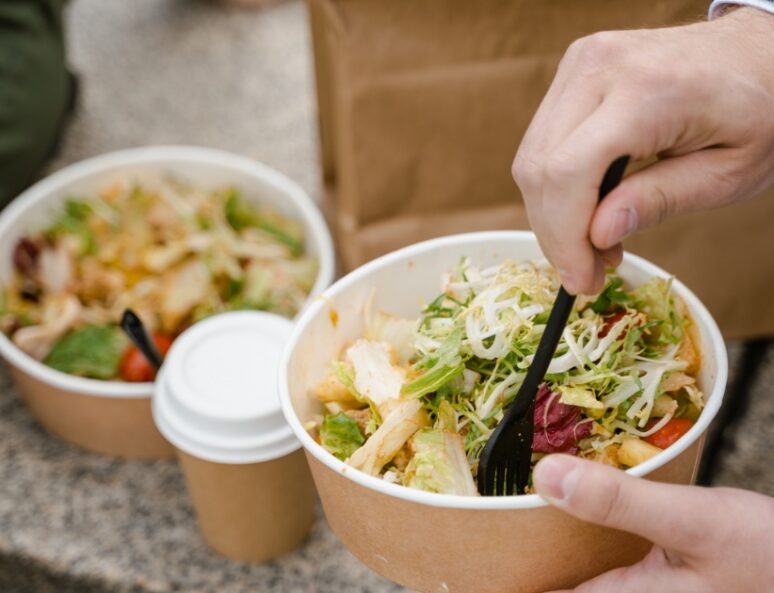 Two salads in disposable packaging