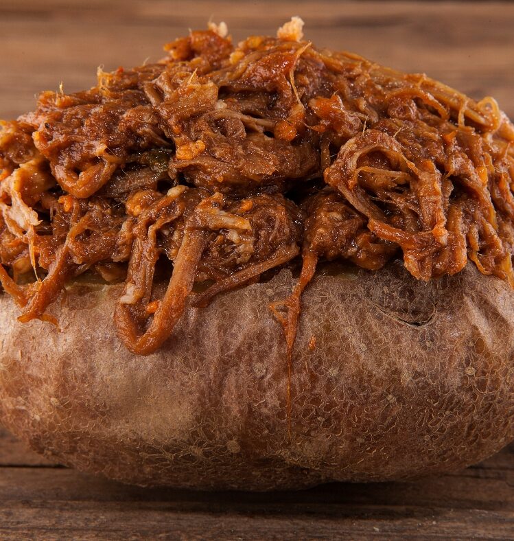 Baked potato topped with braised lamb
