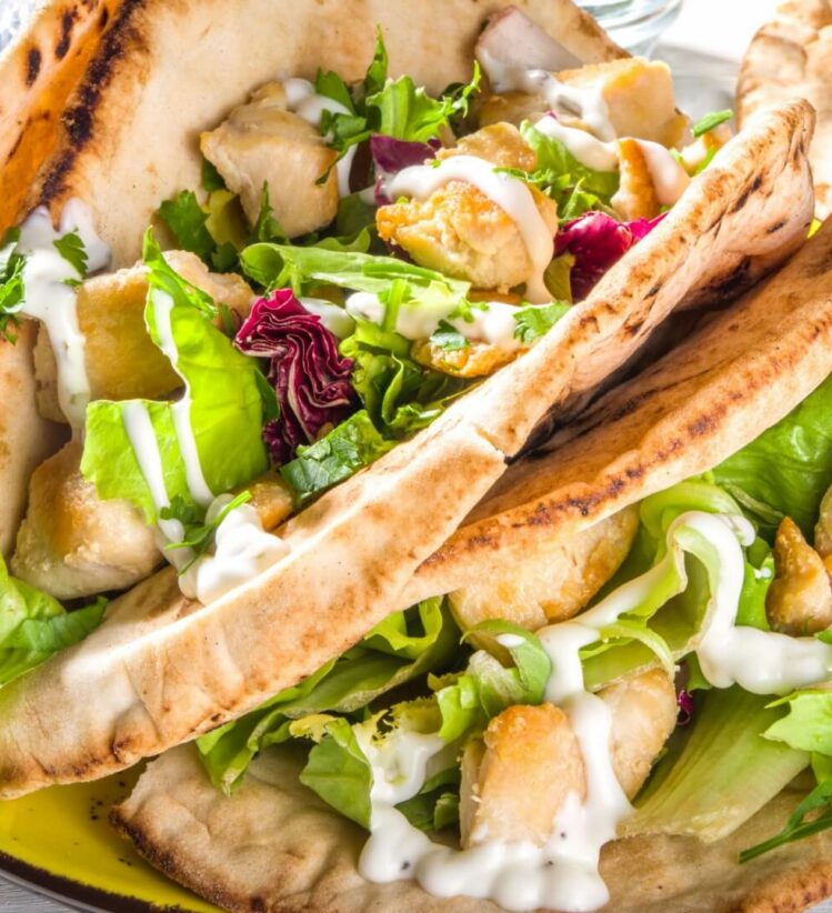 Two chicken gyros on a plate