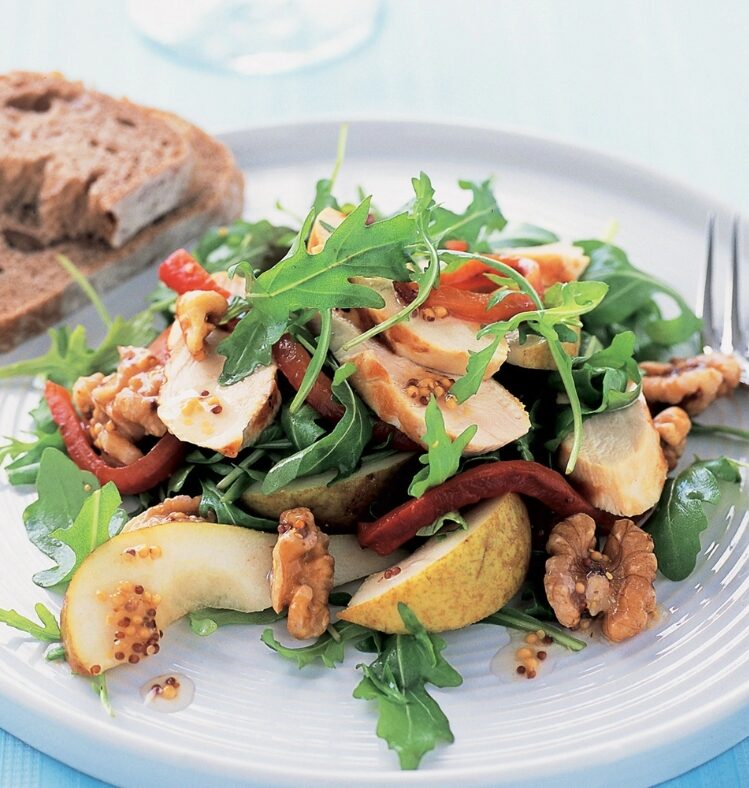 chicken, pear, capsicum and walnut salad next to two slices of toast