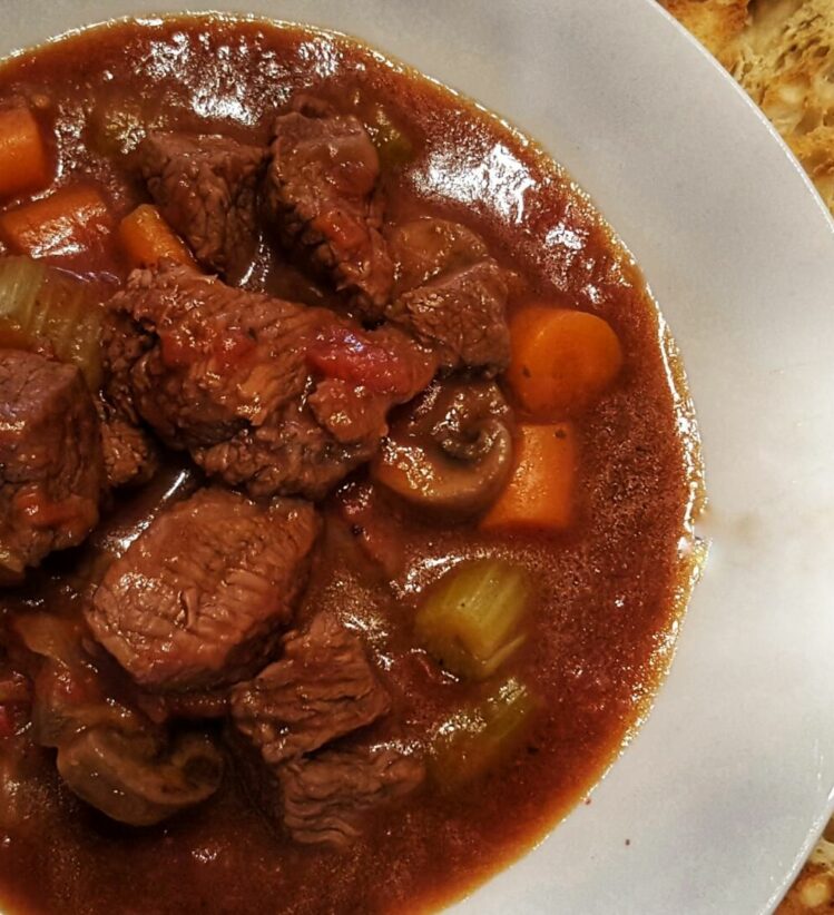 lamb shank, vegetable soup served with toasted bread
