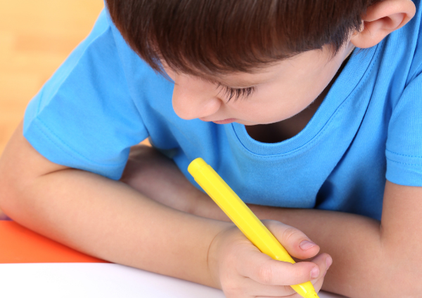 Young boy writing