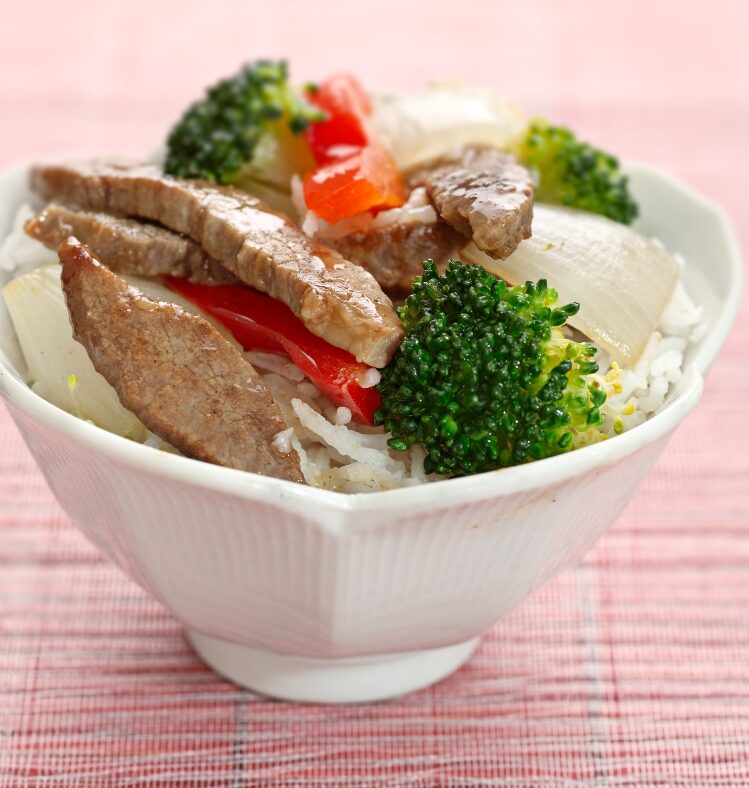 White bowl containing beef and broccoli stri-fry
