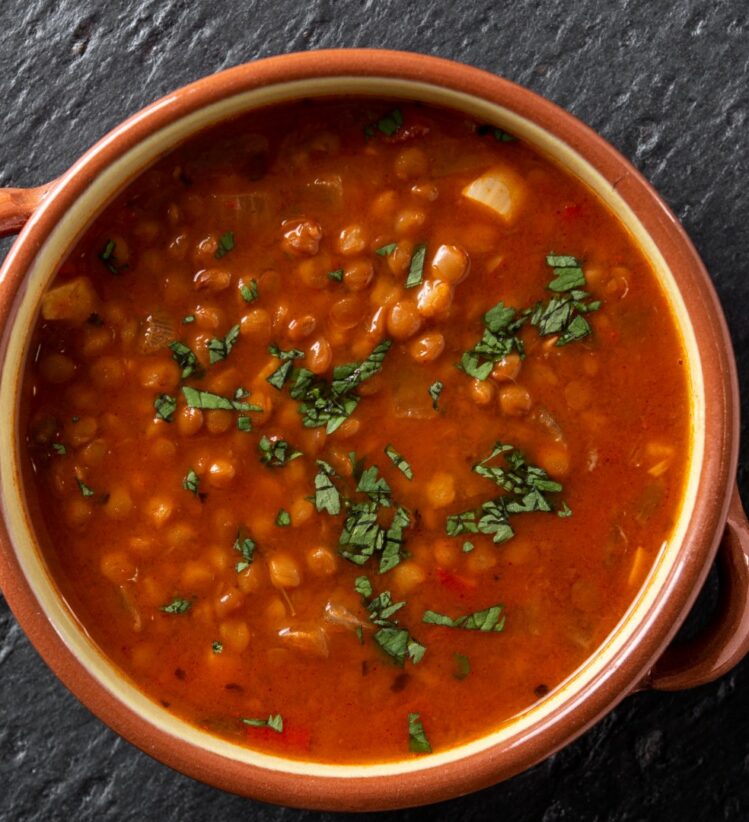 Brown bowl with handles containing Moroccan red lentil soup