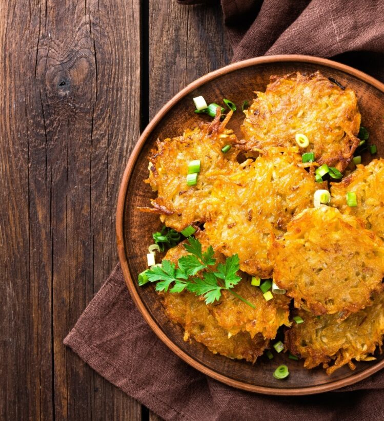 Sweet potato and pumpkin fritters stacked on a plate