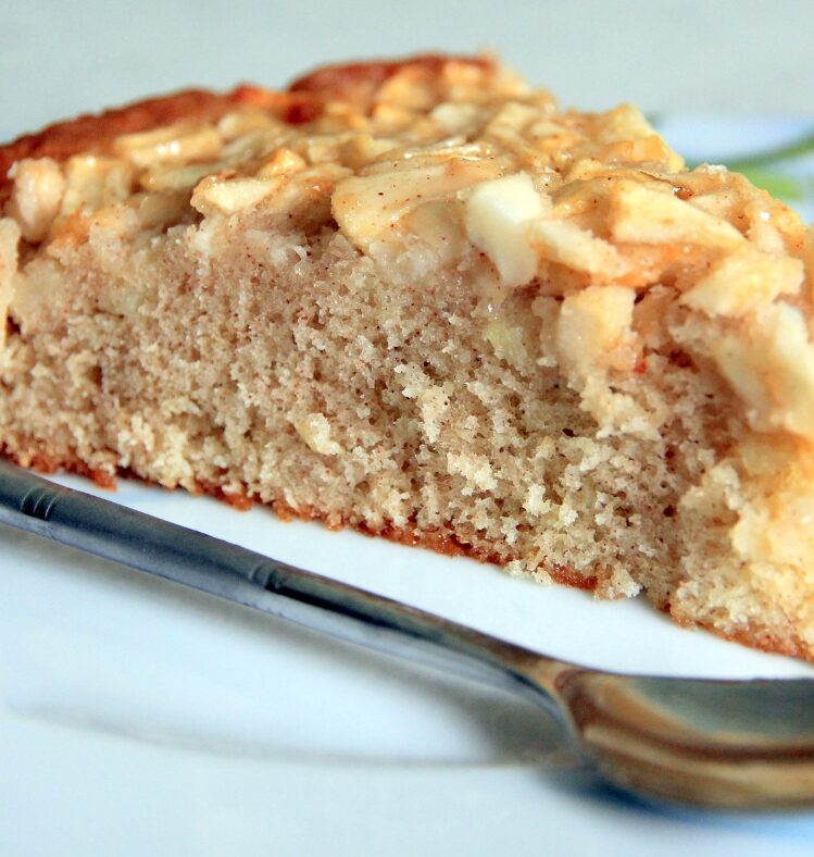 Slice of spiced apple and yoghurt slice with a spoon next to it.