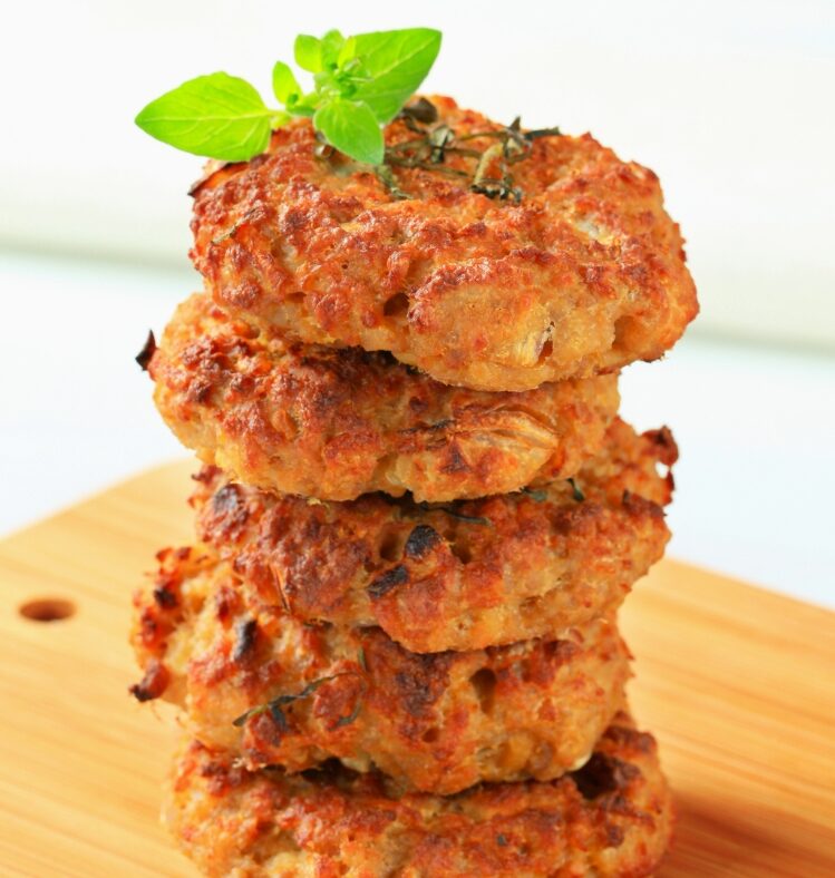 a stack of sweet potato and chickpea patties on a chopping board