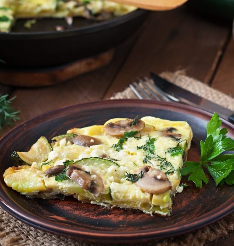 zucchini and mushroom frittata slice in plate