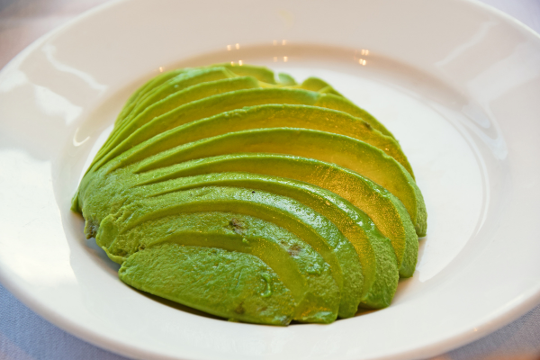 An avocado sliced on a plate