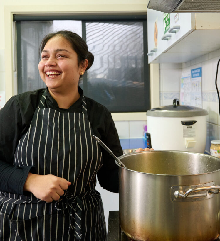 Childcare chef cooking in kitchen with large pot