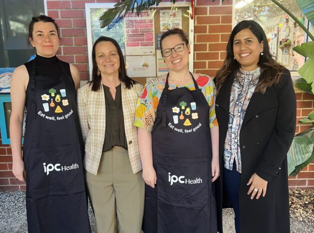 People smiling for the camera in aprons